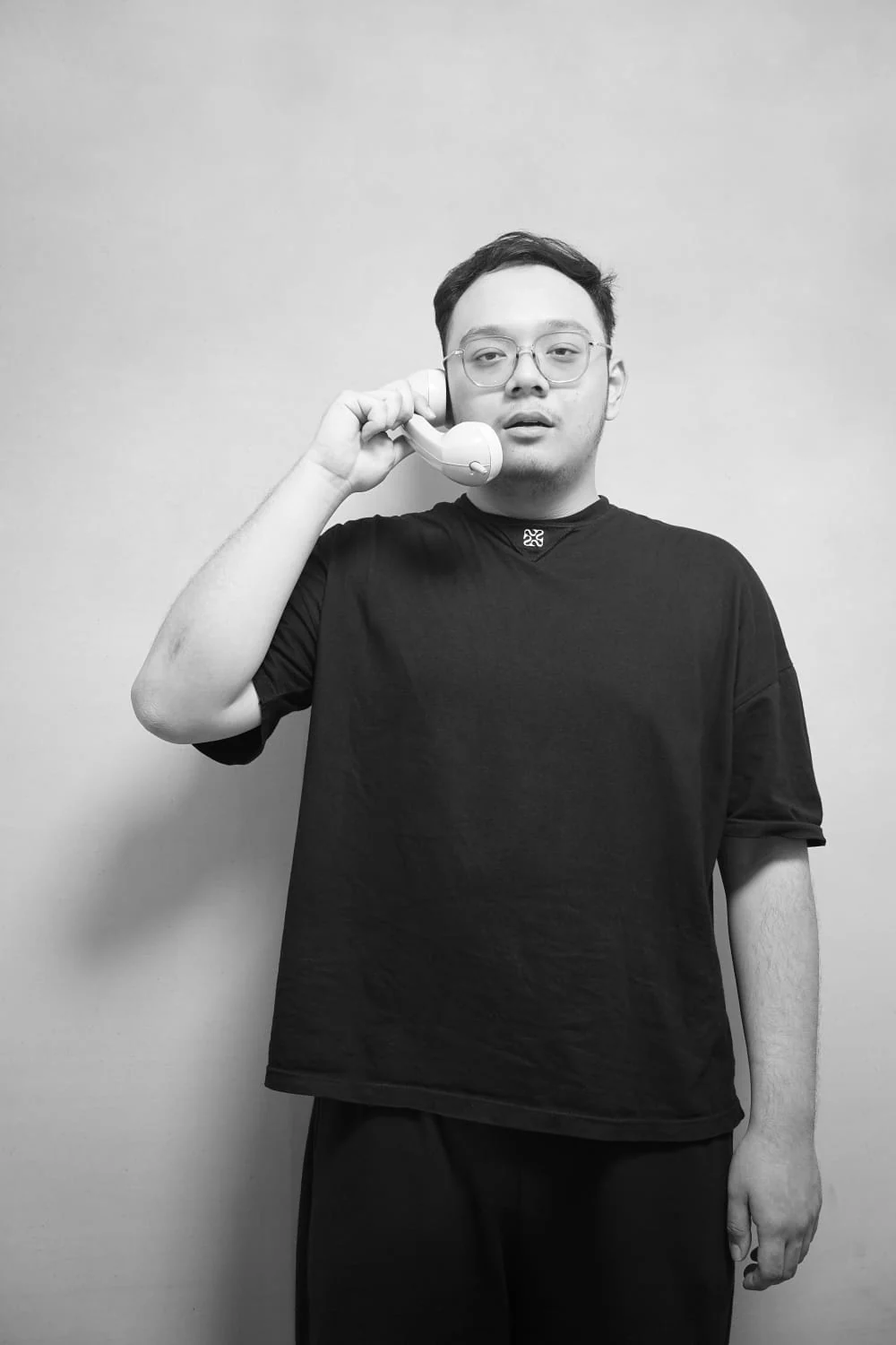 Black-and-white portrait of Desmond holding a telephone receiver